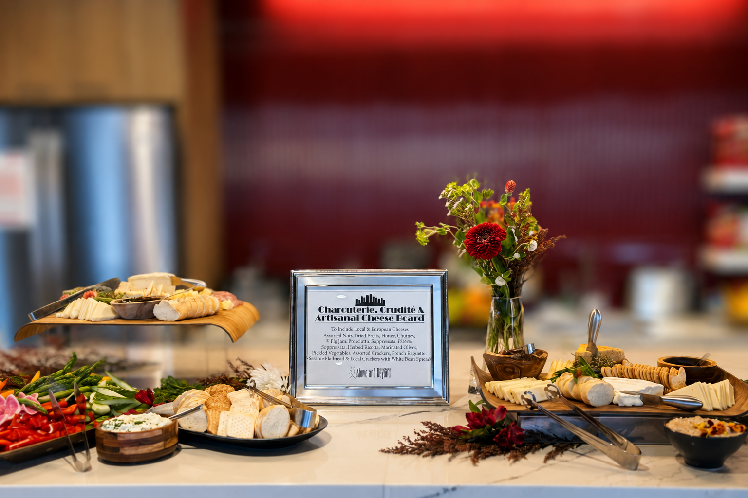 Corporate charcuterie, crudité and artisanal cheese display with fresh flowers