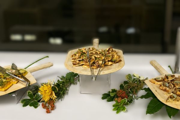 Naan pizza board display with assorted flatbreads and fresh garnishes