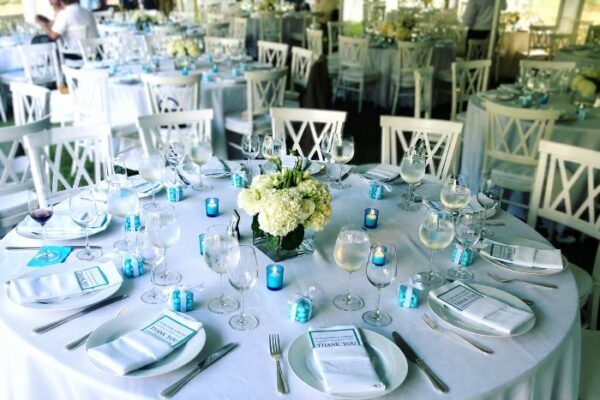 Elegant wedding reception table setting with white florals and turquoise accents